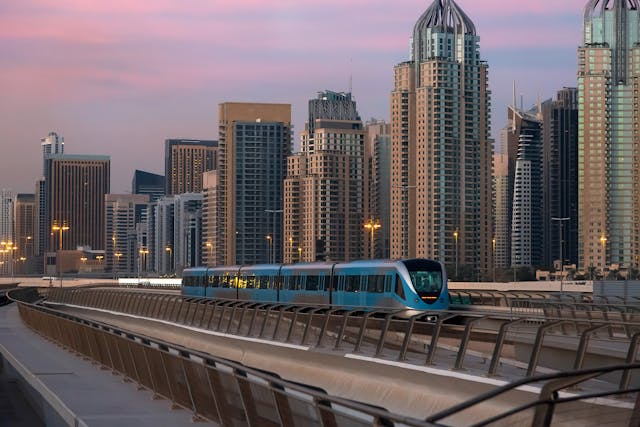 Dubai Metro at Sunset with Iconic Skyline.jpg